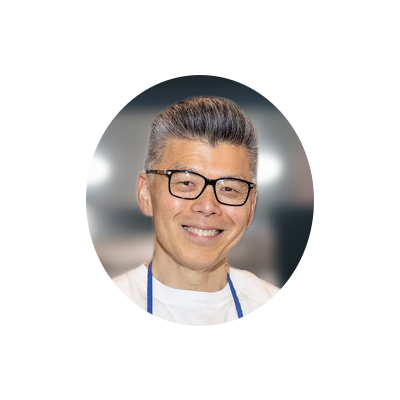 Circular portrait of the Founder with a warm smile